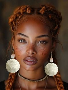 a woman with braids and earrings on her face