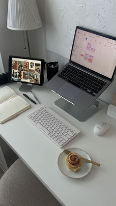 an open laptop computer sitting on top of a white desk