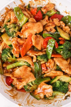 a white bowl filled with chicken, broccoli and bell peppers covered in sauce