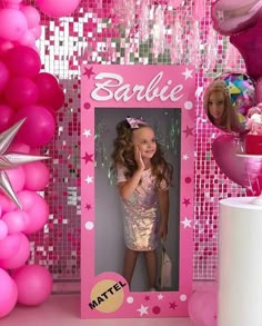 there is a pink photo frame with balloons and stars on the wall next to it