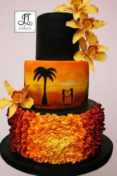 a three tiered cake decorated with flowers and palm trees