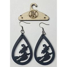 a pair of wooden earrings with an image of a horse on the front and side