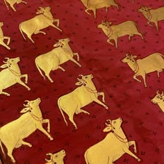 a red table cloth with gold cows on it