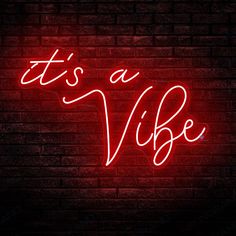 it's a vibe neon sign on a brick wall