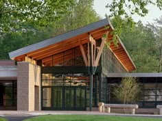 a large building with a wooden roof and glass doors