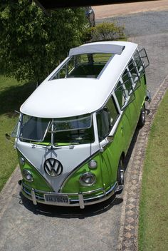 an old vw bus is parked on the side of the road