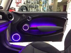 the interior of a car with purple lights