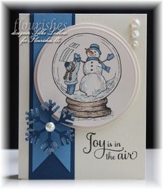 a card with a snow globe on it and the words joy is in the air