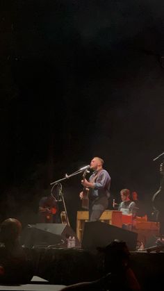 two men on stage with microphones in front of them