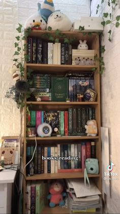 a bookshelf filled with lots of books next to a wall mounted planter