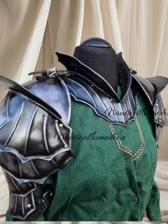 a green shirt with black armor on it