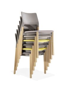 a stack of chairs with yellow and grey plates stacked on top of each other in front of them