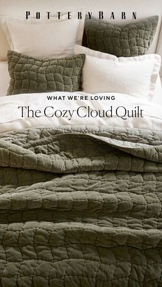 the cozy cloud quilt is made up with white pillows and green blankets on top of it