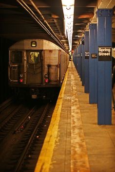 a subway train pulling into the station at night