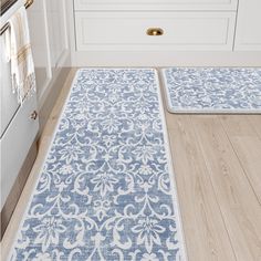 two rugs on the floor in a kitchen