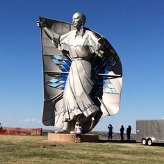 a large statue in the middle of a field