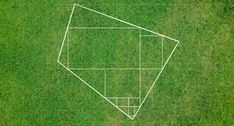 an aerial view of a baseball diamond in the middle of a grassy field with white lines drawn on it