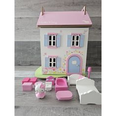 a doll house with furniture and accessories on the floor