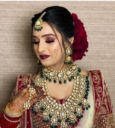 a woman with makeup and jewelry on her face