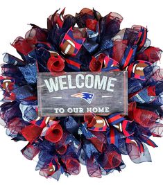 a football wreath with the words welcome to our home on it and red, white, and blue streamers