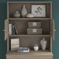 a book shelf with books and vases on it