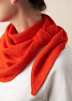 a woman wearing an orange knitted scarf