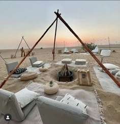 an outdoor seating area is set up on the beach