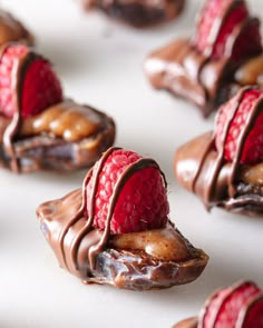 chocolate covered pastries with raspberries on top