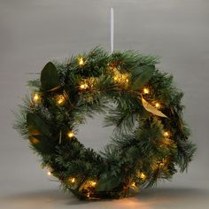 a christmas wreath with lights hanging from it