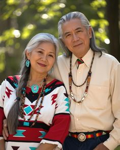 an older man and woman posing for a photo