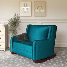 a blue chair with a blanket on it in a living room