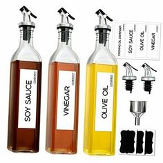 three bottles filled with different types of vinegar and olive oil, each containing an individual's name