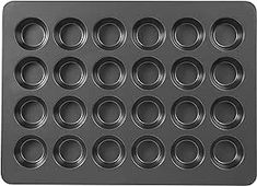 a black muffin tray with circles on it