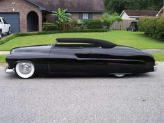 a black car parked in front of a house