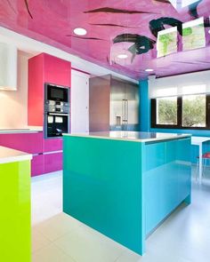 the kitchen is brightly colored and has an island