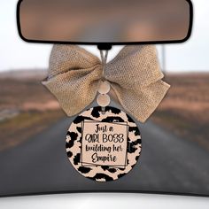 a car door hanger with a bow on it's front window that says, just a girl boss guiding her empire