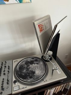 an old record player has been turned into a cd player with the moon on it