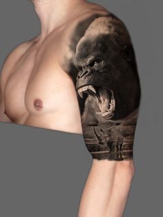 a man's arm with an image of a gorilla and rhinoceros on it