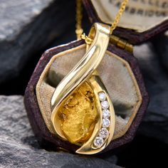 This playful pendant contains one natural gold nugget set in the middle of a "wishbone" design, with six round brilliant cut diamonds channel-set down one side. The pendant measures 28.4mm long by 13.8mm wide and is crafted in 14k yellow gold. It comes on a 14k yellow gold, 18 inch cable chain with jump rings so it can also be worn at 16 inches and 17 inches long. Gia Certified Yellow Gold Pendant Jewelry, Yellow Gold Nugget Fine Jewelry, Luxury Yellow Gold Nugget Necklace, Wishbone Pendant Necklace, Artisan Yellow Pendant Jewelry, Gold Nugget Pendant, Antique Engagement Rings Sapphire, Natural Gold Nugget, Estate Jewelry Rings