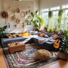 a living room filled with lots of furniture and plants on top of a rug in front of a window