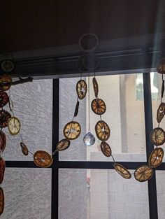 a window with some clocks hanging from it