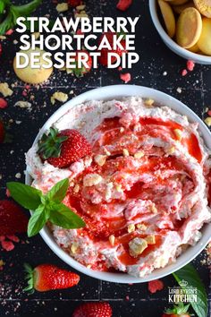 strawberry shortcake dessert dip in a bowl with fresh strawberries and mint leaves on the side