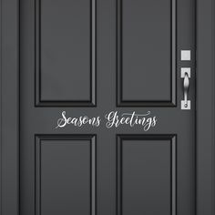 a black door with the words seasons greetings written on it