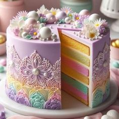 there is a cake that has been decorated with pastel colors and flowers on it