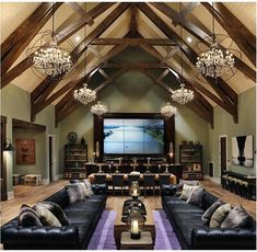 a living room filled with lots of furniture and chandelier hanging from the ceiling