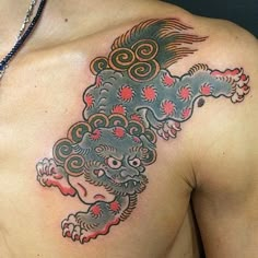 a man with a dragon tattoo on his chest