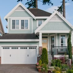 a large house with two garages in front of it