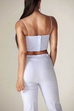 Our 'Carla' crop structure top is beautifully crafted from a crepe fabric in a off white tone to welcome in the warmer season. Inspired by traditional crop top, The boning provides corset-inspired structure and support that snatches the figure and we love the ruching across the bust to enhance the feminine feel in a 90's inspired straight neckline held by delicate spaghetti straps.We think the cropped length works well with a 'Niaz' high waisted wide legs pants.It has adjustable hooks and eyes t Traditional Crop Top, Baby Crop Top, White Tone, Straight Neckline, 90s Inspired, Modern Dress, Wide Legs, Crepe Fabric, Baby Blue