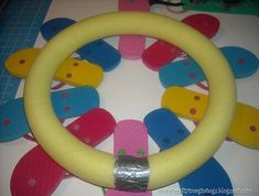 the steering wheel cover is made out of plastic and has colorful clips attached to it