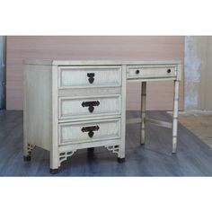 an old white desk with three drawers